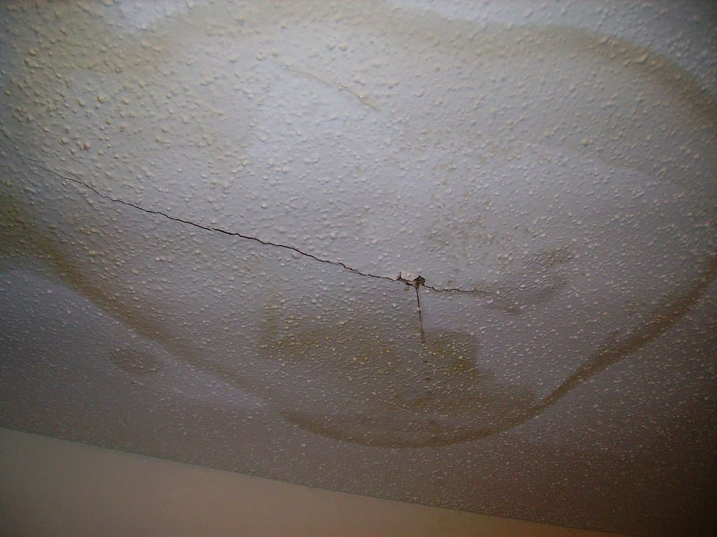 Water leaking through a stained ceiling